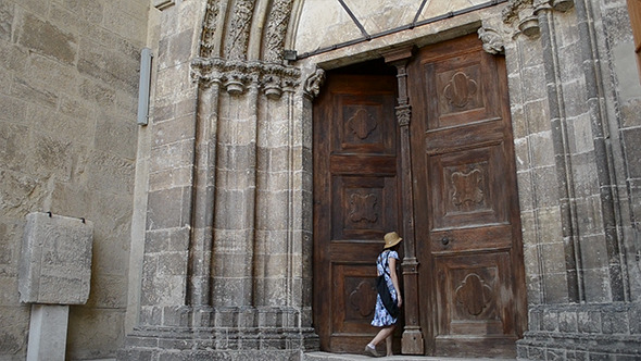 Woman Enters Medieval Door