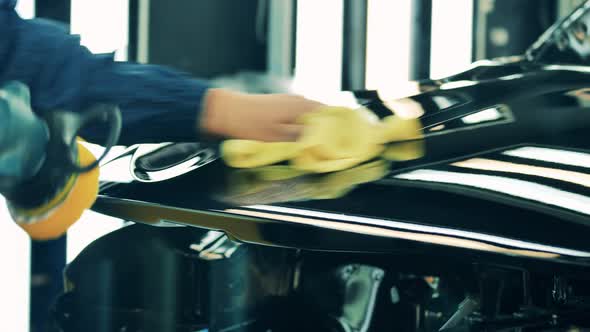 Car Factory Worker Polishing a Car Body