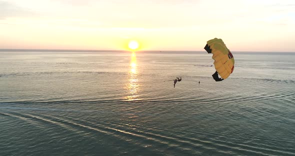 Aerial View of Karon Beach in The Evening with Paragliding Fly Pass the Shot.