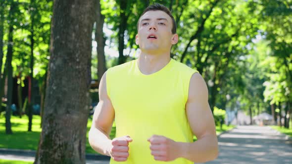 Jogger Stopping and Taking a Breath in Park