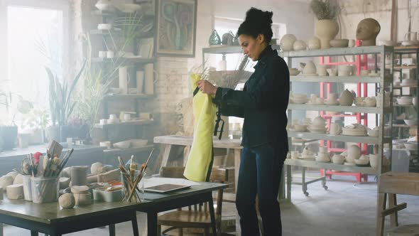 Woman Is Putting On Apron