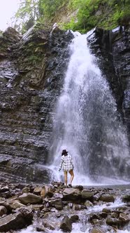 Pretty Hiker Woman Standing in Front of Big Waterfall