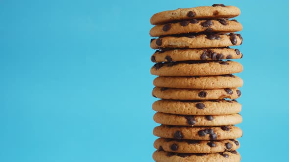 A Stack Chocolate Chip Cookies Rotate on a Blue Background