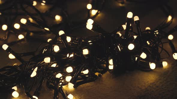 Closeup Shot Hank of Christmas Garland with Golden Lights on a Playd