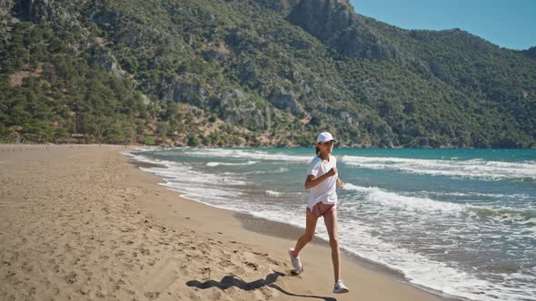 Woman Silhouette Running on Beach Waves Splashing Female Runner Exercising Sprinting Intense Workout