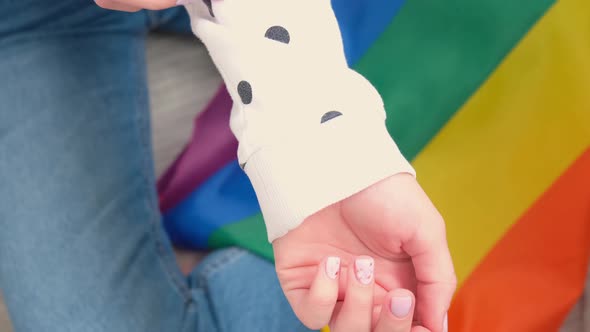 Closeup of Young Caucasian Millennial Hippie Woman Showing Rainbow Flag in Heart Shape Painted in