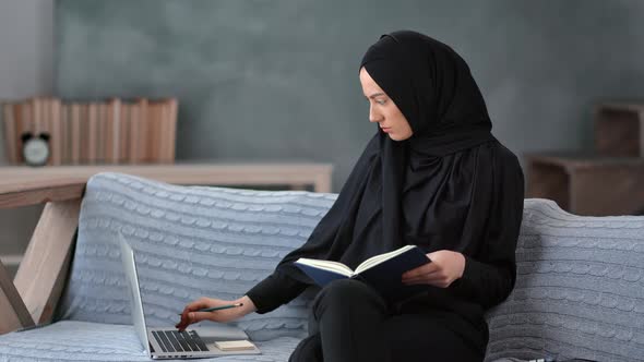 Focused Muslim Woman Student Distance Elearning Making Notes Use Laptop