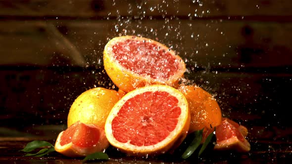 Super Slow Motion on Fresh Pieces of Grapefruit Drop Drops of Water