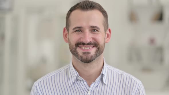 Portrait of Happy Young Man Smiling at Camera