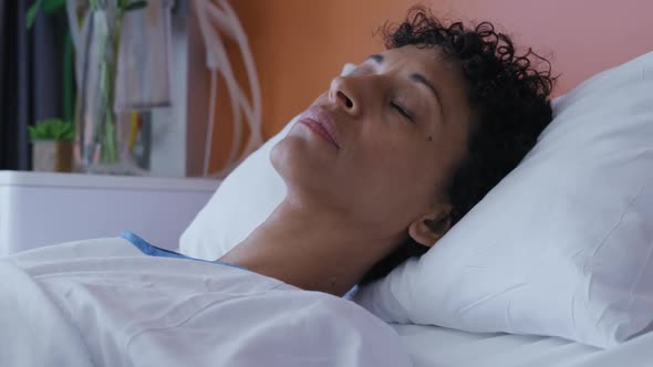 Female patient lying in a hospital bed