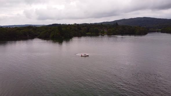 aerial shot passing motorboat on lake Windermere lake district