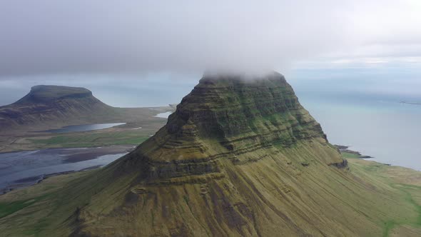 Aerial view of Kirkjufell Mountain during foggy weather.