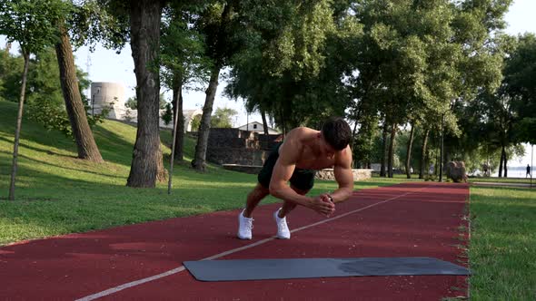 Muscular Man Doing Pushups with Clapping on Fitness Mat with Naked Body Triceps