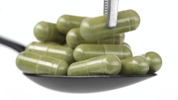 put one capsule moringa or spirulina on spoon