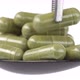 put one capsule moringa or spirulina on spoon - VideoHive Item for Sale