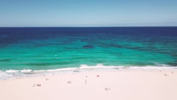 Aerial view of beautiful coast line with beach and colored blue ocean