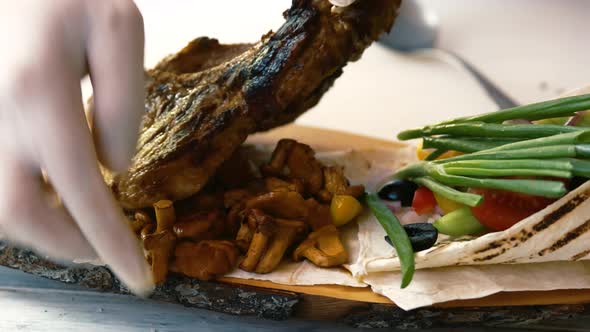 Hand of Chef and Steak.