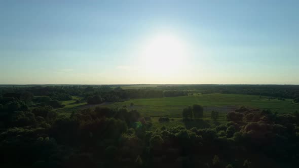 Aerial View Sunset or Sunrise in Field Drone Shot Beautiful Summer Sun in Forest