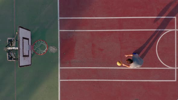 Man Playing Basketball on the Court