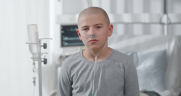 Portrait of Sad Suffering Teen Boy Fighting with Cancer