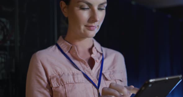 Caucasian female it technician using tablet checking computer server