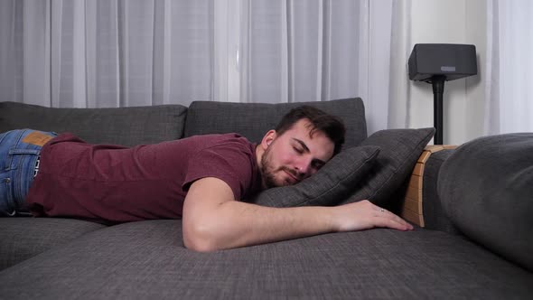 Tired Man Falling onto Couch to Take a Nap, Slow Motion