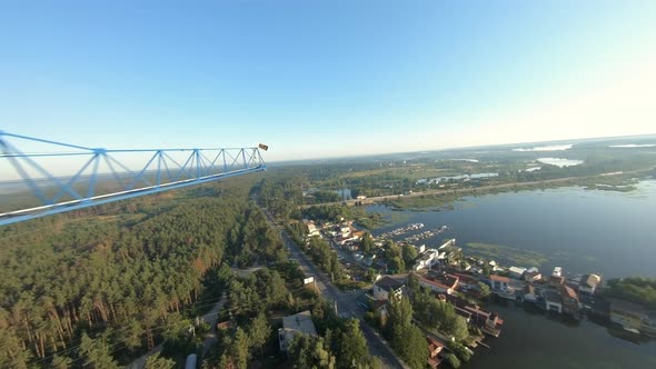 FPV Drone View Quickly Flies Near a Construction Crane and an Unfinished Apartment Building at Dawn