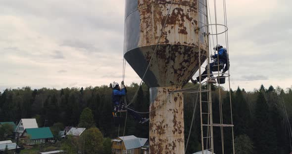 Industrial Climbers Paint the Iron Tower