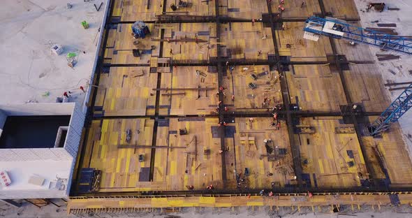 View of the Construction Site of a Shopping Center with a Crane Jib and Workers