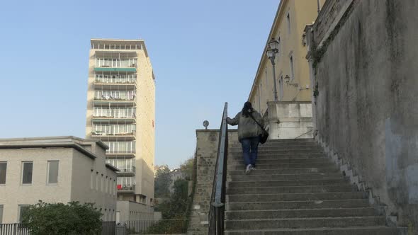 Low angle of a woman climbing stairs