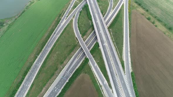 Aerial high drone flight over Highway and overpass. Road junction