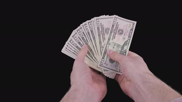 Male Hands Holding a Fan of a Lot of 50 Dollar Bills with Alpha Channel