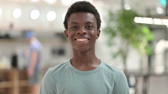 Smiling Young African Man Looking at Camera