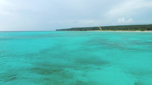 Aerial forward over turquoise sea of Bahia de las Aguilas. Dominican Republic