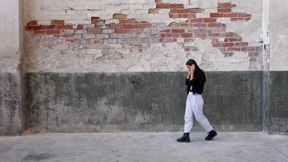 Woman with headphones dancing to music she is listening to