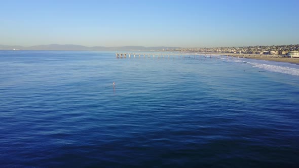 Aerial drone uav view of a pier over the beach and ocean.