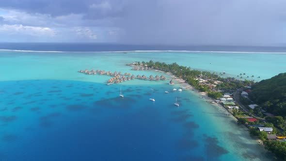 Aerial drone view of a luxury resort and overwater bungalows in Bora Bora tropical island