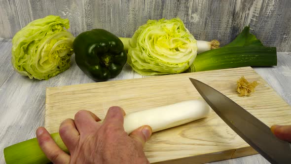 Cutting leeks into thin slices, cooking vegetables