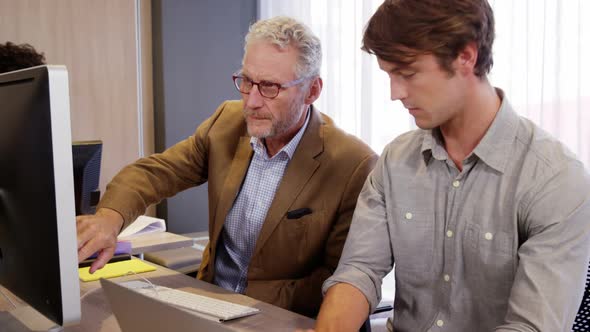 Businessman interacting with his coworker while working