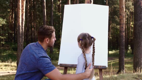 Happy Family Young Father Drawing Coloring Picture with Brush Helping Cute Child Daughter Enjoying