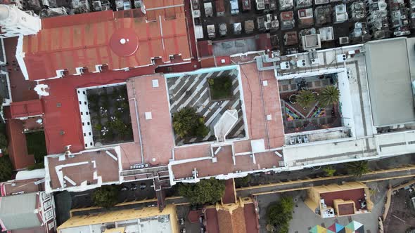 Aerial top down shot rising above The Recoleta cultural centre and cemetery beside