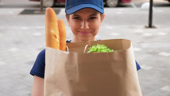 Close Up Smiling Food Delivery Woman Courier Deliver Paper Bag of Groceries