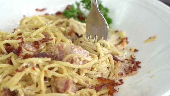 slow motion of Spaghetti Carbonara with fork