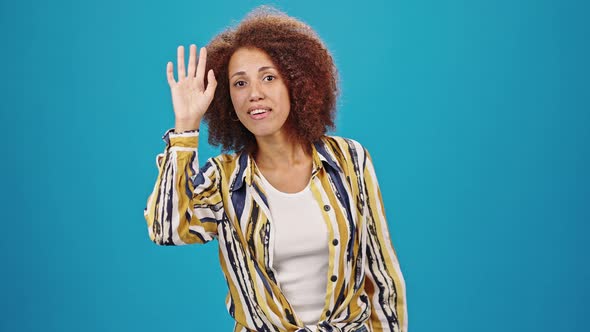 Cheerful Woman Looks for Companion Waving Hello and Smiling