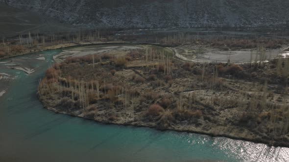 Aerial View Over Winding River Bend On Valley Floor Landscape Of Gilgit Baltistan. Circle Dolly