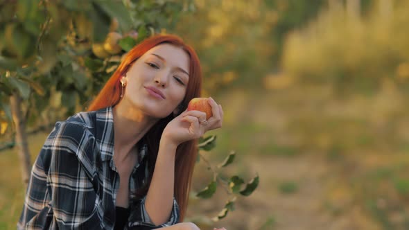 Woman on Nature with Apple in a Hand