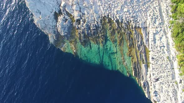 View from above of dangerous Dalmatian cliffs immersed in crystal clear sea