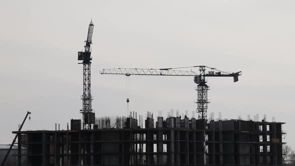 Time Lapse of Construction Cranes and Workers Silhouettes