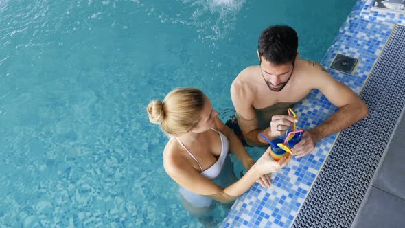 Picture of Happy Couple Relaxing in Pool