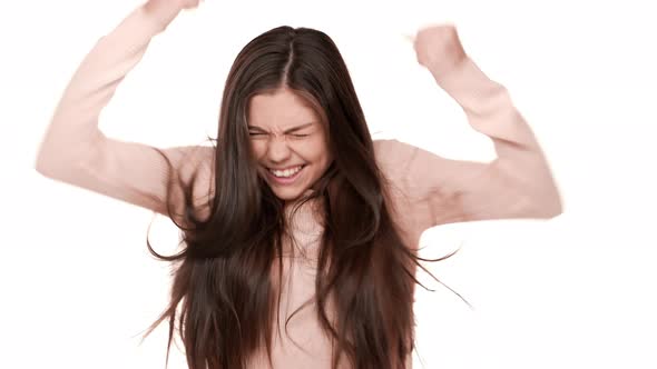 Portrait of Delighted Teen Lady Being Ecstatic Clenching Fists with Excitement Screaming Yes